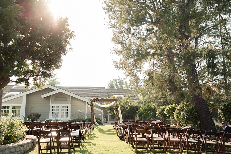 Outdoor Ceremony Decorated Wooden Arch Wooden Chairs Trees Luxe Outdoor Garden Wedding in California http://figlewiczphotography.com/