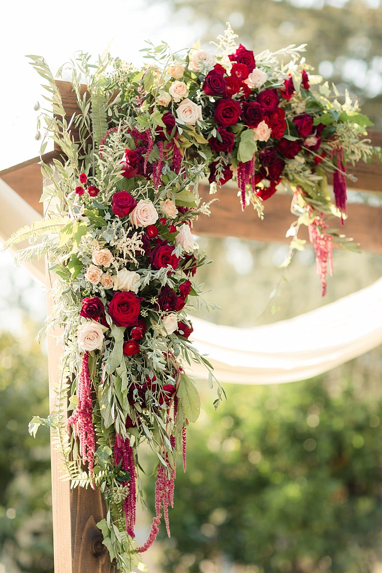 Outdoor Ceremony Decorated Wooden Arch Fresh Florals Red Cream Pink Roses Amaranth Greenery Luxe Outdoor Garden Wedding in California http://figlewiczphotography.com/