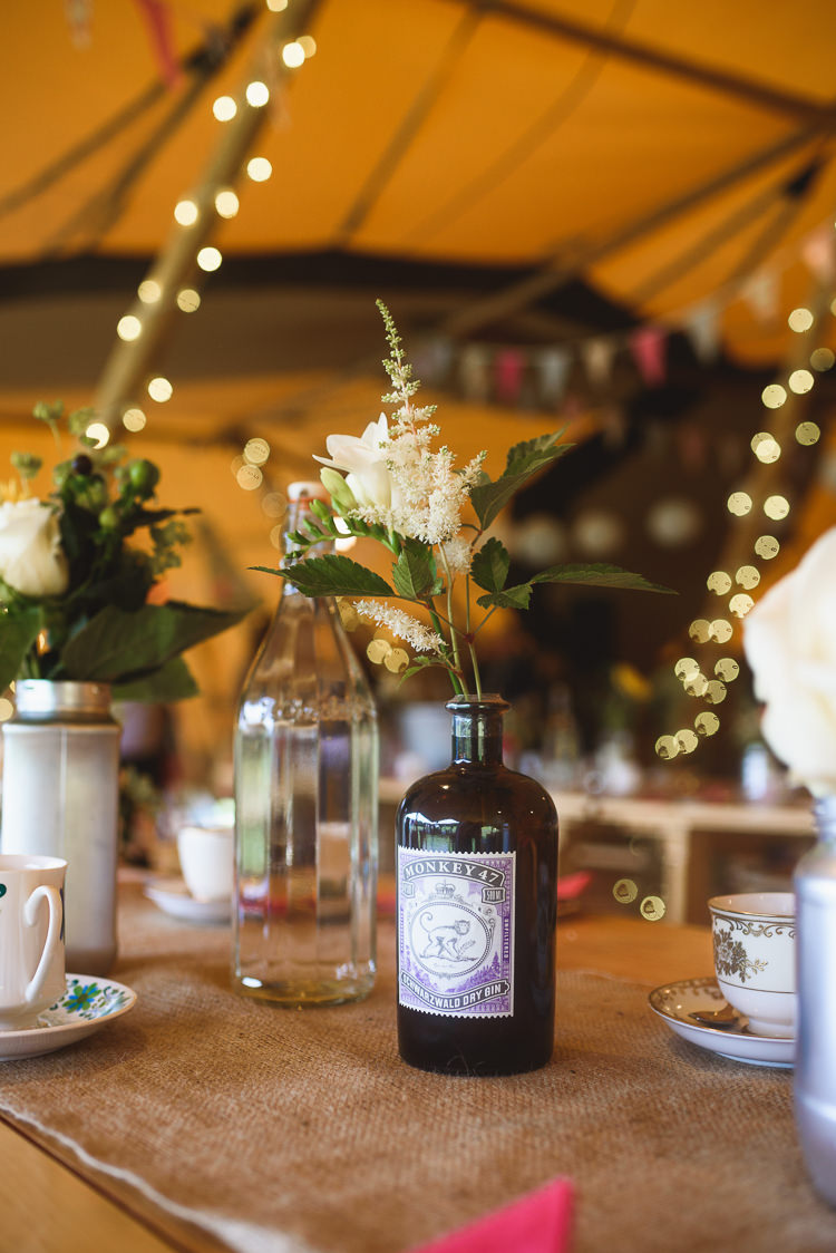 Gin Bottle Flowers Decor Centrepiece Colourful Outdoorsy Festival Tipi Wedding http://www.jacksonandcophotography.com/