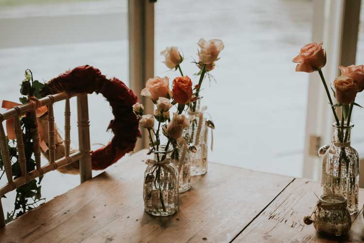Coral Pink Flowers Bottles Rose Gold Autumn Barn Wedding http://www.weddingphotographyincheltenham.co.uk/