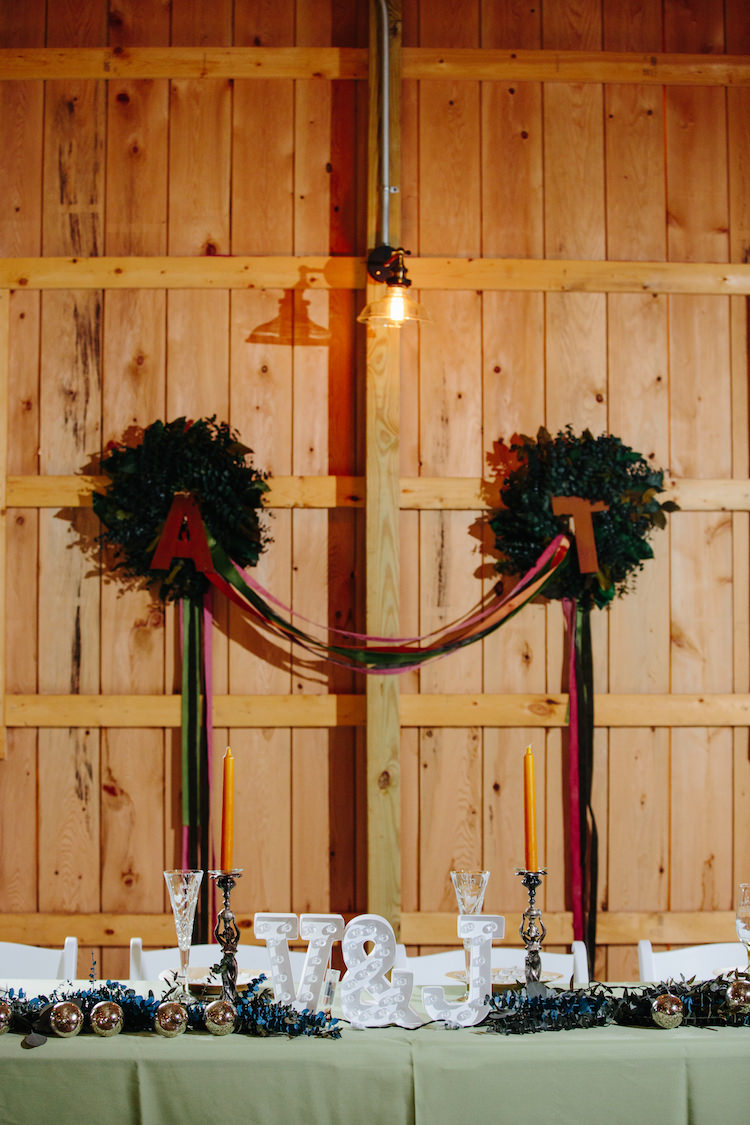 Barn Reception Bridal Table Greenery Wreath Coloured Ribbons Initial Lights Greenery Orange Candlesticks Art Nouveau Autumn Burgundy Wedding http://www.jbonadiophoto.com/