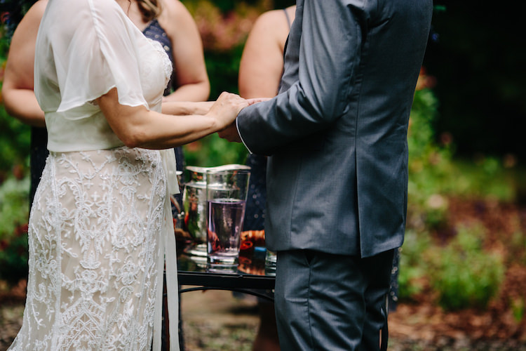 Outdoor Ceremony Bride Strapless Lace Watters Bridal Gown Sheer Top Groom Grey Suit Hold Hands Art Nouveau Autumn Burgundy Wedding http://www.jbonadiophoto.com/