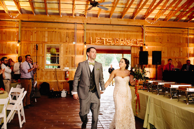 Barn Reception Lit Let's Dance Sign Fairy Lights Bride Strapless Lace Watters Bridal Gown Bouquet Dried Flowers Feathers Orange Velvet Ribbon Groom Grey Suit Black Vest Green Bowtie Pocket Square Guests White Chairs Art Nouveau Autumn Burgundy Wedding http://www.jbonadiophoto.com/