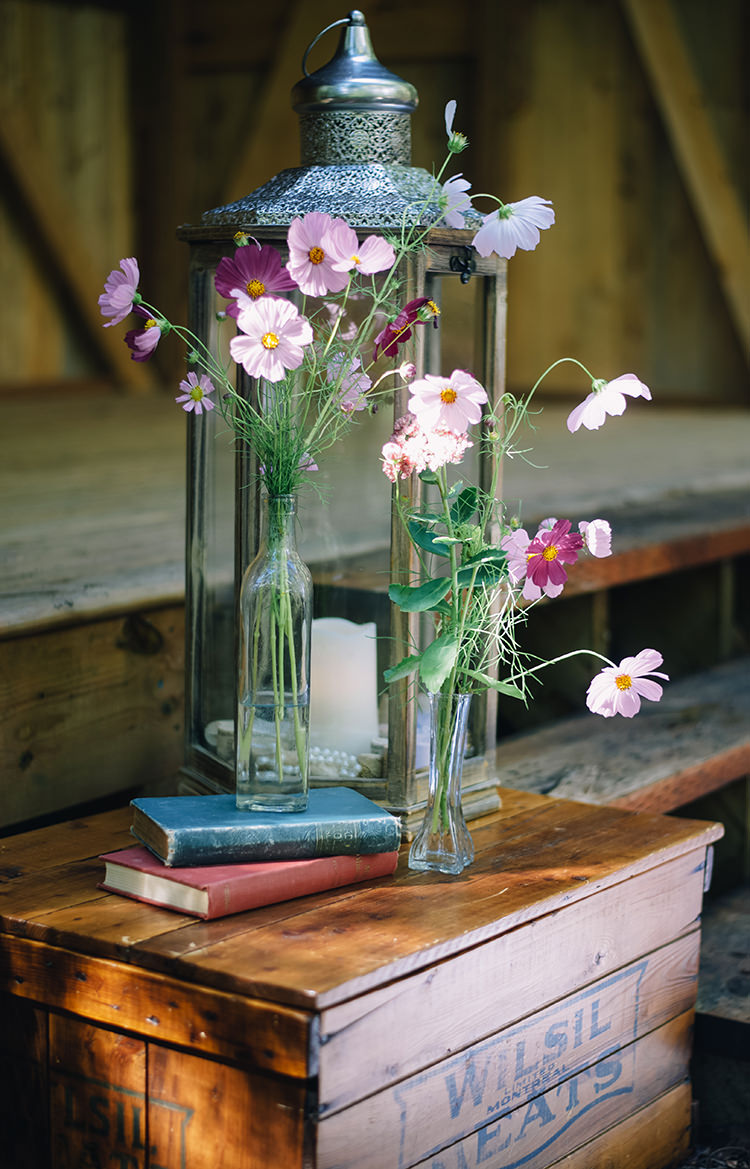 Outdoor Ceremony Rustic Décor Silver Candle Lantern Fresh Pink Purple Florals Glass Vases Vintage Books Wooden Box Woodland Waterfall Mint Wedding Ontario http://www.laurenmccormickphotography.com/