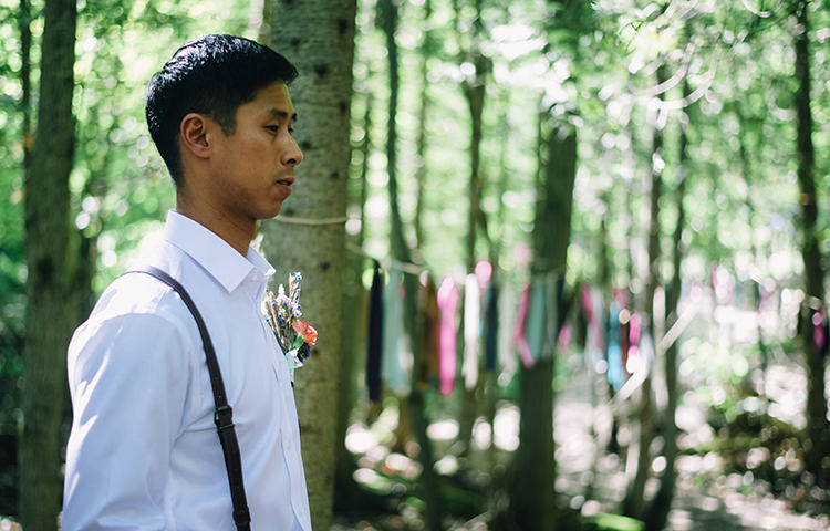 Outdoor Ceremony Groom White Shirt Brown Leather Suspenders Multicoloured Floral Buttonhole Hanging Décor Ribbons Trees Woodland Waterfall Mint Wedding Ontario http://www.laurenmccormickphotography.com/