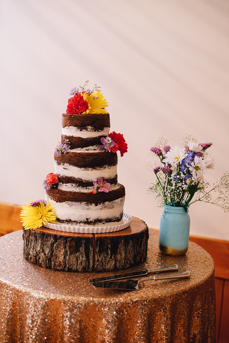 Wedding Cake Multilayered Naked Cake Fresh Multicoloured Florals Tree Slice Cake Stand Mint Gold Vase Pink White Purple Flowers Sequinned Rose Gold Tablecloth Woodland Waterfall Mint Wedding Ontario http://www.laurenmccormickphotography.com/