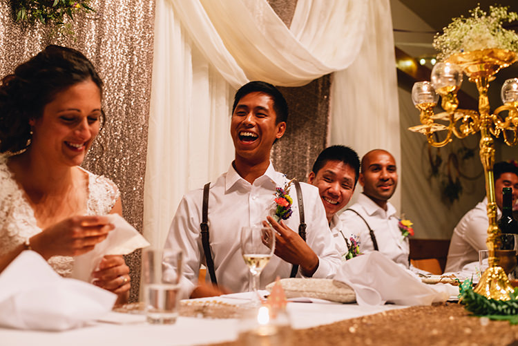 Reception Bride Groom White Shirt Brown Leather Suspenders Multicoloured Floral Buttonhole Groomsmen Sequinned Rose Gold Backdrop White Tulle Gold Candle Holder Woodland Waterfall Mint Wedding Ontario http://www.laurenmccormickphotography.com/