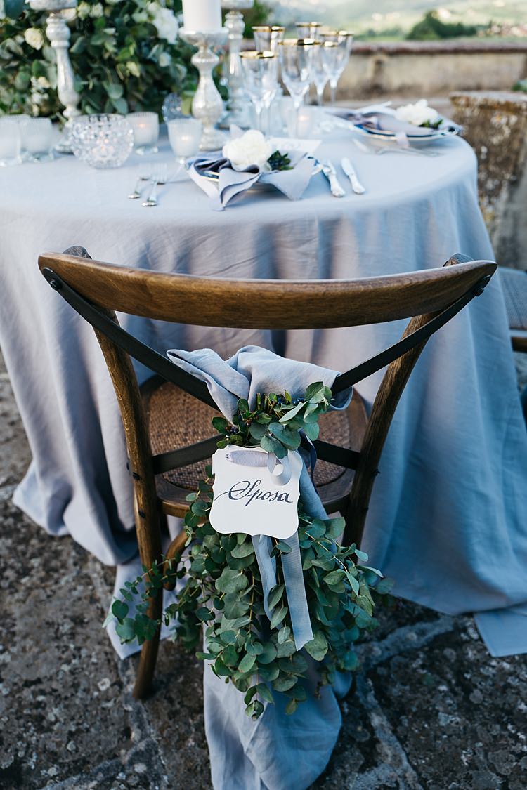 Reception Table Setting Wooden Chair Calligraphy Tag Grey Ribbon Greenery Grey Tablecloth Silver Candlesticks Rustic Chic Greenery Wedding Ideas in Tuscany http://www.tastino0.it/