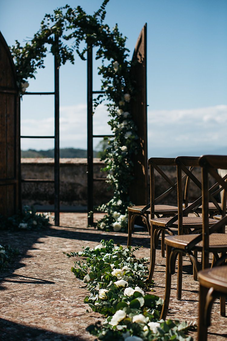 Outdoor Ceremony Wooden Archway White Florals Greenery Wooden Chairs Rustic Chic Greenery Wedding Ideas in Tuscany http://www.tastino0.it/