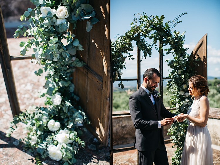 Outdoor Ceremony Bride High Neck Lace Tulle Bridal Gown Buttons Groom Charcoal Pinstripe Suit Green Patterned Bowtie Wooden Archway White Roses Greenery Rustic Chic Greenery Wedding Ideas in Tuscany http://www.tastino0.it/