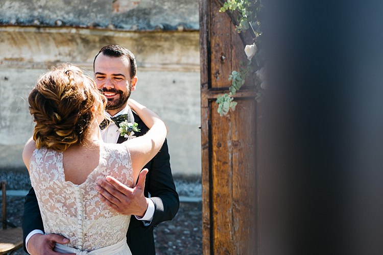 Outdoor Ceremony Bride High Neck Lace Tulle Bridal Gown Buttons Groom Charcoal Pinstripe Suit Green Patterned Bowtie Wooden Archway Rustic Chic Greenery Wedding Ideas in Tuscany http://www.tastino0.it/