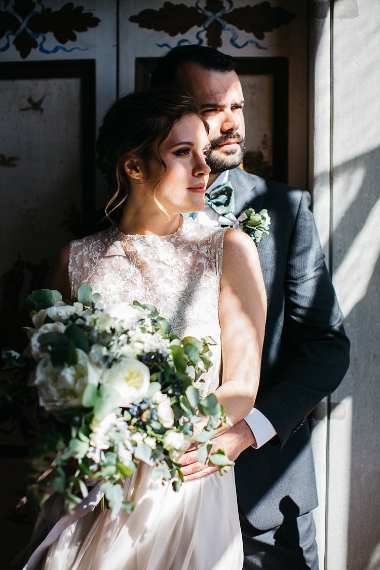 Bride High Neck Lace Tulle Bridal Gown Bouquet White Roses Greenery Groom Charcoal Pinstripe Suit Green Patterned Bowtie Shadows Rustic Chic Greenery Wedding Ideas in Tuscany http://www.tastino0.it/