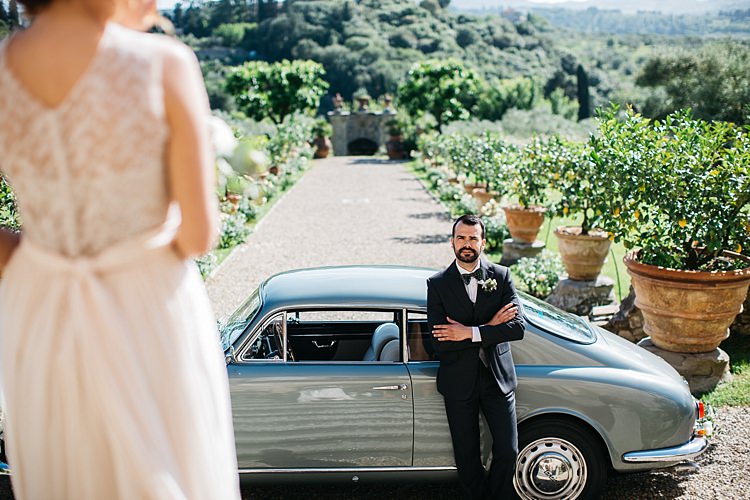 Vintage Grey Car Bride High Neck Lace Tulle Bridal Gown Buttons Groom Charcoal Pinstripe Suit Green Patterned Bowtie Large Potted Plants Rustic Chic Greenery Wedding Ideas in Tuscany http://www.tastino0.it/