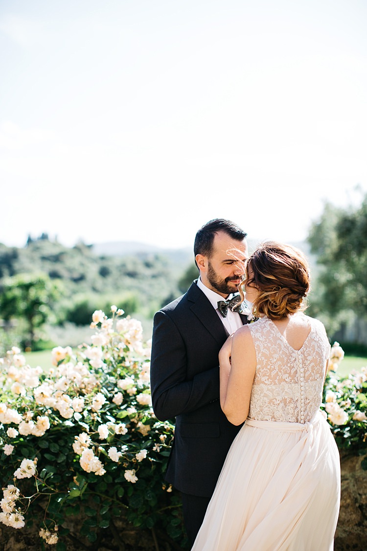 Bride High Neck Lace Tulle Bridal Gown Buttons Groom Charcoal Pinstripe Suit Green Patterned Bowtie White Rose Bush Rustic Chic Greenery Wedding Ideas in Tuscany http://www.tastino0.it/