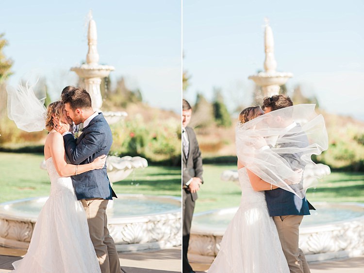 Outdoor Ceremony First Kiss Bride Lace Sweetheart Strapless Bridal Gown Veil Groom Navy Jacket Beige Pants Light Green Tie Celebrant Water Fountain Soft Blush Sage Green Wedding California http://julia-rosephotography.com/