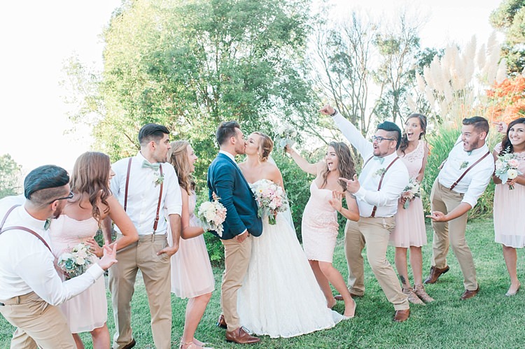 Bridal Party Bride Lace Sweetheart Strapless Bridal Gown Veil Bouquet White Pink Green Florals Groom Navy Jacket Light Green Tie Beige Pants Bridesmaids Blush Multi Style Dresses Bouquets Groomsmen White Shirts Green Bowties Leather Suspenders Beige Pants Soft Blush Sage Green Wedding California http://julia-rosephotography.com/