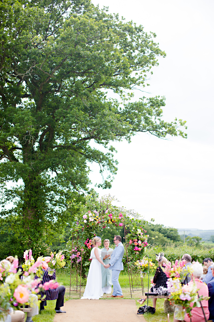 Outdoor Ceremony UK Arch Flowers Colourful Pastel Home Made Farm Wedding http://helencawtephotography.com/