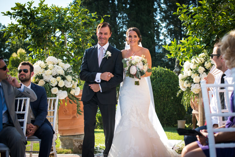 Outdoor Ceremony Bride Lace Fitted Mermaid Bridal Gown Bouquet White Pink Peony Florals Father Entrance Guests White Chairs White Roses Greenery Romantic Outdoor Castle Tuscany Wedding http://www.natalymontanari.com/