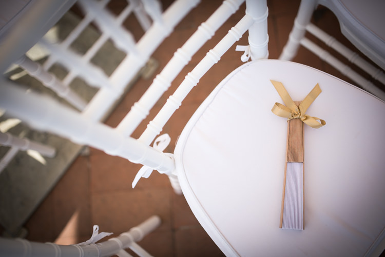 Outdoor Ceremony White Chairs Lace Fan Gold Ribbon Romantic Outdoor Castle Tuscany Wedding http://www.natalymontanari.com/