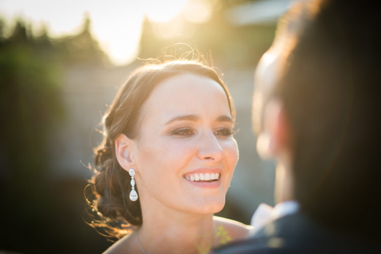 Bride Soft Bun Hairstyle Crystal Drop Earrings Groom Black Suit Sunset Romantic Outdoor Castle Tuscany Wedding http://www.natalymontanari.com/