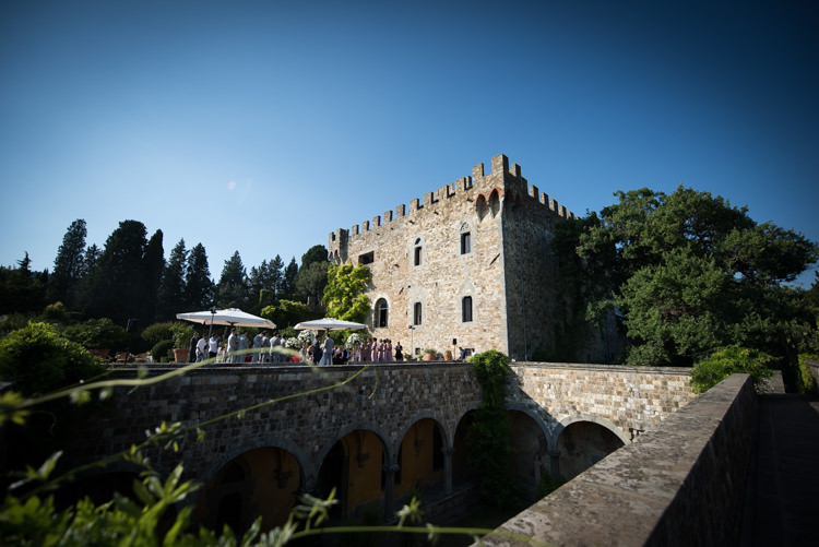 Outdoor Ceremony Guests Large Umbrellas Trees Scenery Romantic Outdoor Castle Tuscany Wedding http://www.natalymontanari.com/