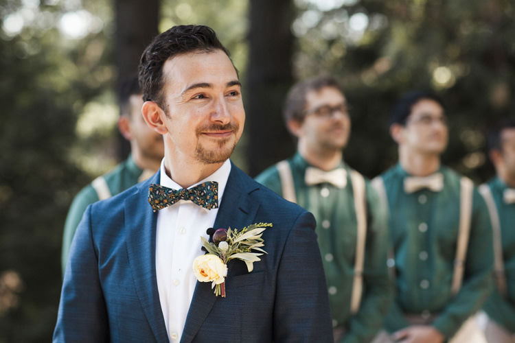 Outdoor Ceremony Groom Dark Blue Suit White Shirt Patterned Bowtie Floral Buttonhole Groomsmen Green Shirts Beige Suspenders Bowties Whimsical Forest Harry Potter Wedding http://heatherelizabethphotography.com/