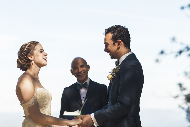 Outdoor Ceremony Bride Sarah Seven Cascade Lace Off The Shoulder Bridal Gown Crystal Hairpiece Groom Dark Blue Suit Patterned Bowtie Floral Buttonhole Celebrant Whimsical Forest Harry Potter Wedding http://heatherelizabethphotography.com/
