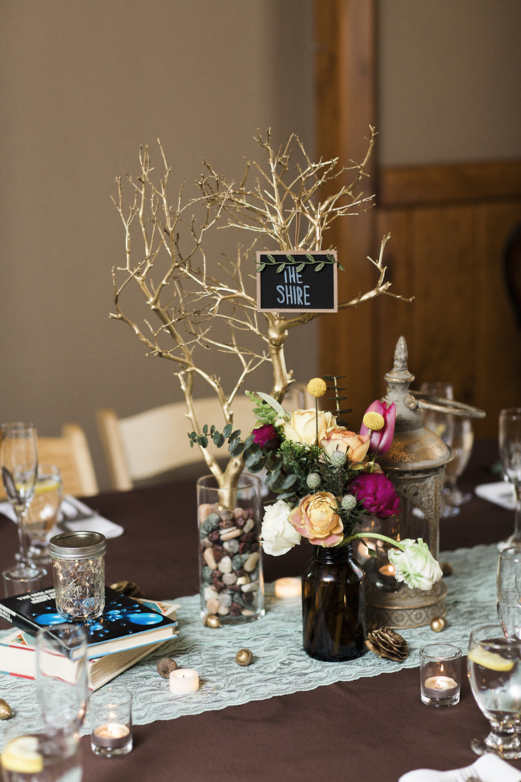 Reception Table Setting Book Lover Theme Painted Branch Blackboard Sign Place Name Glass Vase Stones Dark Bottle Multicoloured Florals Books Candles Whimsical Forest Harry Potter Wedding http://heatherelizabethphotography.com/