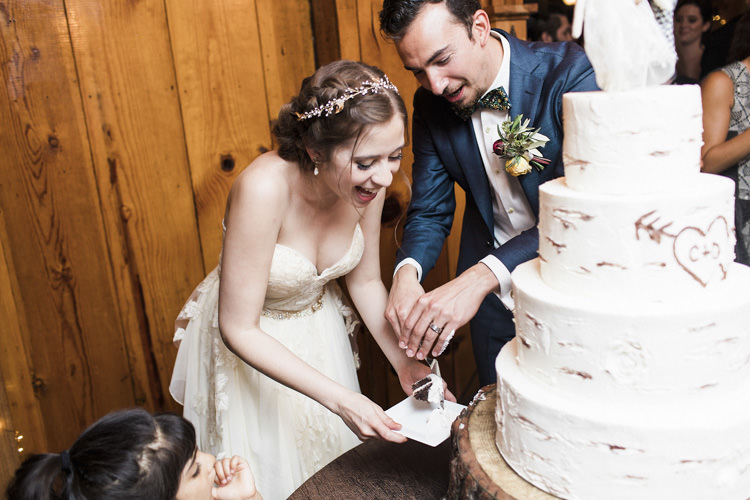 Reception Cake Cutting Bride Sarah Seven Cascade Lace Bridal Gown Crystal Hairpiece Groom Dark Blue Suit Patterned Bowtie Floral Buttonhole Whimsical Forest Harry Potter Wedding http://heatherelizabethphotography.com/