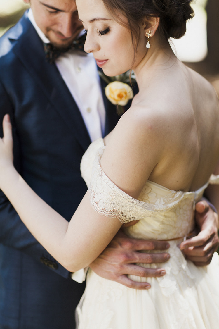 First Look Bride Sarah Seven Cascade Lace Off The Shoulder Bridal Gown Embellished Belt Drop Earrings Groom Dark Blue Suit Patterned Bowtie Floral Buttonhole Whimsical Forest Harry Potter Wedding http://heatherelizabethphotography.com/