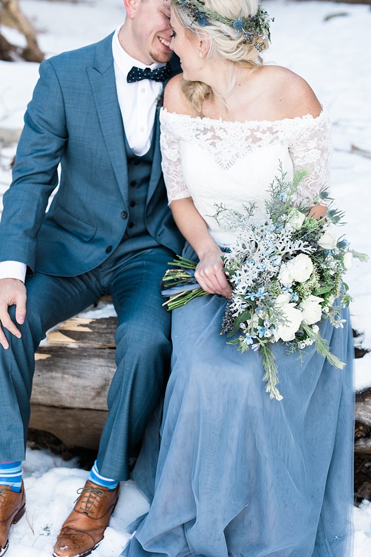 Bride Lace Off The Shoulder Top Blue Long Skirt Floral Crown Bouquet White Blue Green Flowers Groom Blue Suit Navy Polka Dot Bowtie Blue Striped Socks Brown Leather Shoes Snowy Winter Wonderland Anniversary Shoot http://ryannlindseyphotography.com/