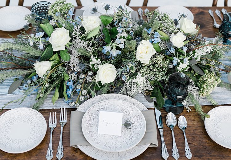 Outdoor Reception Wooden Table Blue Grey Fabric Fresh White Blue Green Flowers Patterned Plates Calligraphy Name Cards Snowy Winter Wonderland Anniversary Shoot http://ryannlindseyphotography.com/