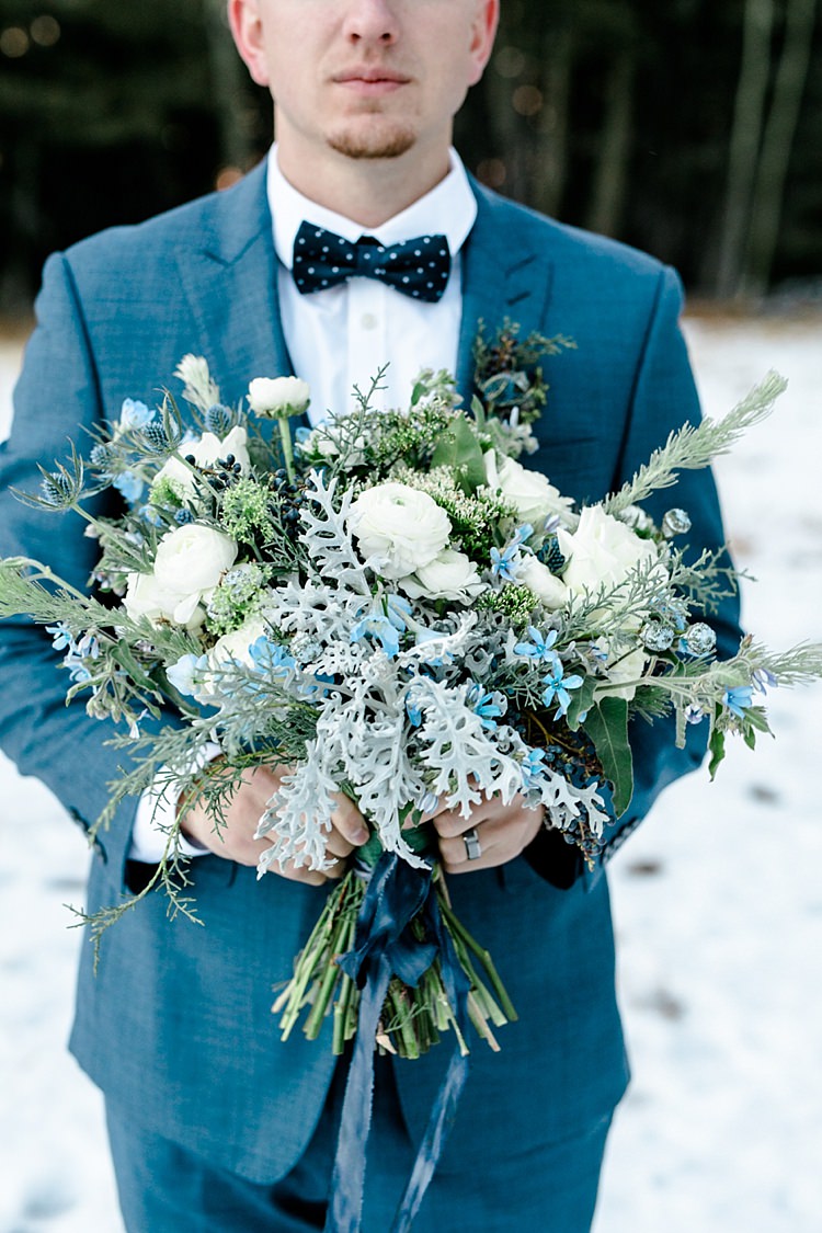 Groom Blue Suit Navy Polka Dot Bowtie Bridal Bouquet White Blue Green Flowers Blue Ribbon Snowy Winter Wonderland Anniversary Shoot http://ryannlindseyphotography.com/