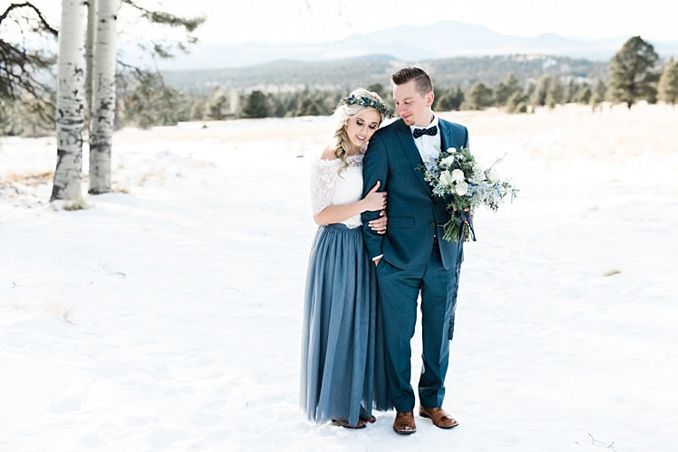 Bride Lace Off The Shoulder Top Blue Long Skirt Floral Crown Bouquet White Blue Green Flowers Groom Blue Suit Navy Polka Dot Bowtie Brown Leather Shoes Snowy Winter Wonderland Anniversary Shoot http://ryannlindseyphotography.com/