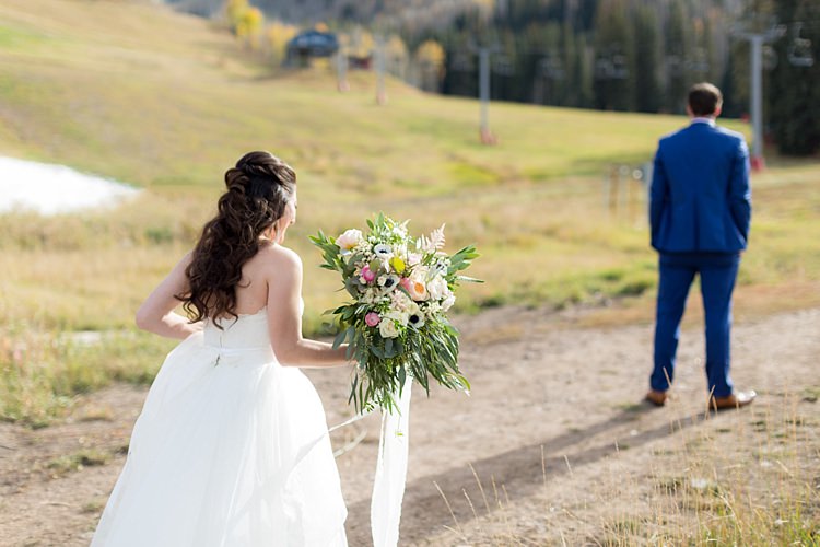 Outdoor First Look Bride Strapless Lace Ballgown Bridal Gown Bouquet Multicoloured Pastel Roses Peonies Anemones Greenery Florals Groom Blue Suit Romantic Mountain Wedding Colorado http://irvingphotographydenver.com/