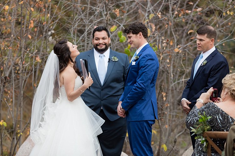 Outdoor Ceremony Bride Strapless Lace Ballgown Bridal Gown Veil Groom Blue Suit White Shirt Light Blue Tie Celebrant Groomsman Guests Romantic Mountain Wedding Colorado http://irvingphotographydenver.com/