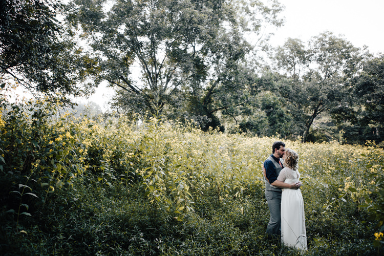 Bride Handmade Lace Bridal Gown Groom Grey Vest Pants Navy Blue Shirt Yellow Flowers Adventure Inspired Woodland Wedding North Carolina http://www.amandasuttonphotography.com/