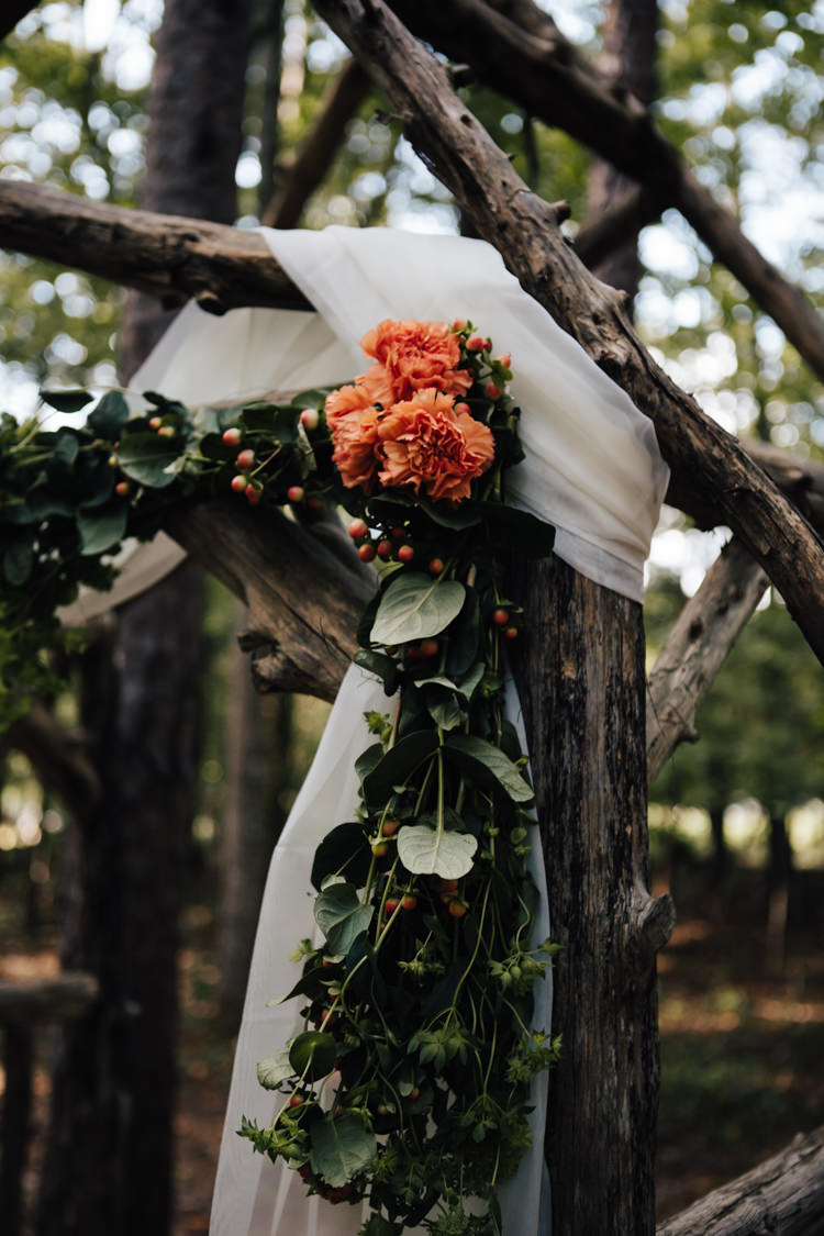 Outdoor Ceremony Decorated Wooden Arbour White Organza Orange Florals Greenery Adventure Inspired Woodland Wedding North Carolina http://www.amandasuttonphotography.com/