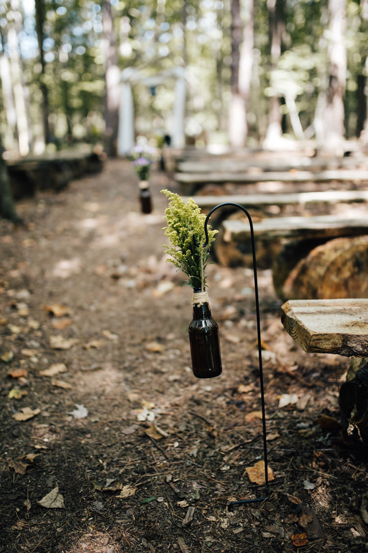 Outdoor Ceremony Wooden Bench Seating Beer Bottles Fresh Florals Twine Adventure Inspired Woodland Wedding North Carolina http://www.amandasuttonphotography.com/
