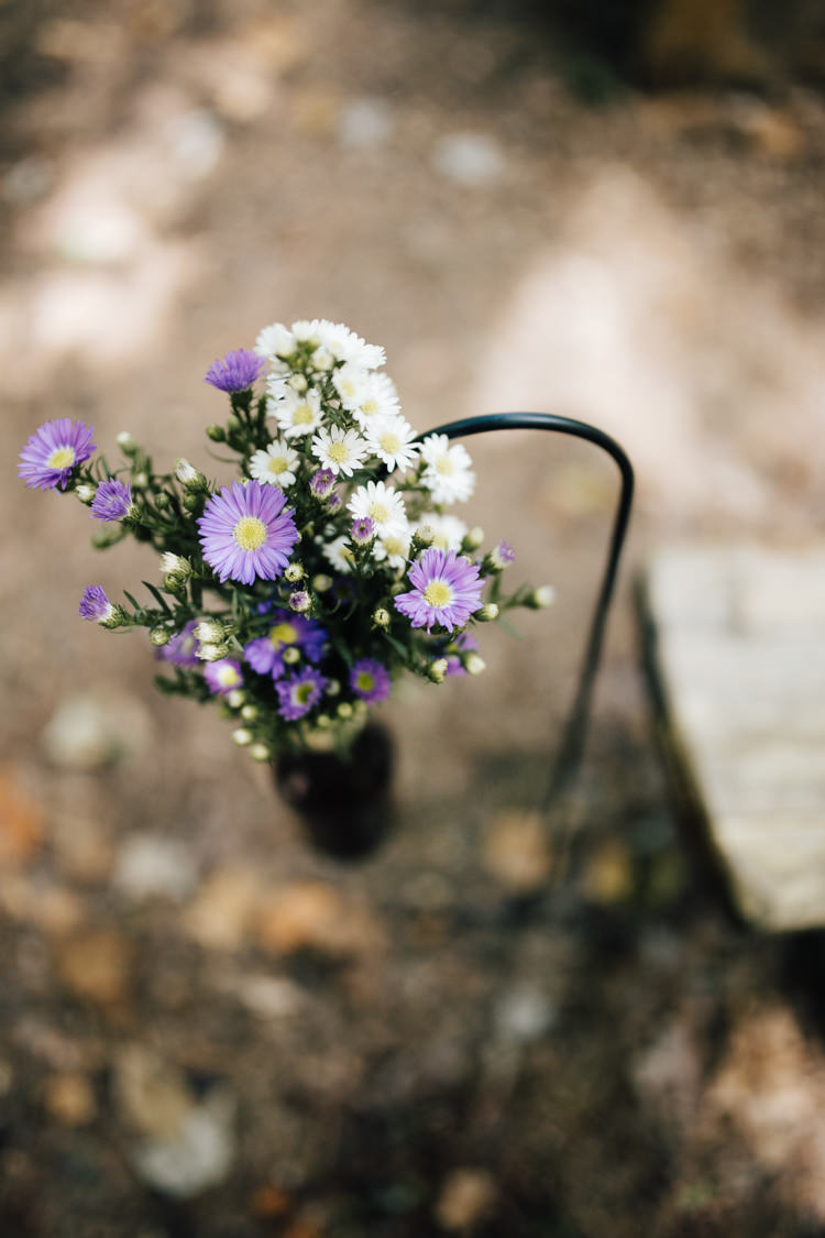 Outdoor Ceremony Fresh Florals Purple White Beer Bottle Wooden Bench Seating Adventure Inspired Woodland Wedding North Carolina http://www.amandasuttonphotography.com/