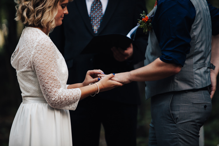 Outdoor Ceremony Bride Handmade Lace Bridal Gown Groom Grey Vest Pants Navy Blue Shirt Buttonhole Orange Florals Succulent Celebrant Ring Exchange Adventure Inspired Woodland Wedding North Carolina http://www.amandasuttonphotography.com/
