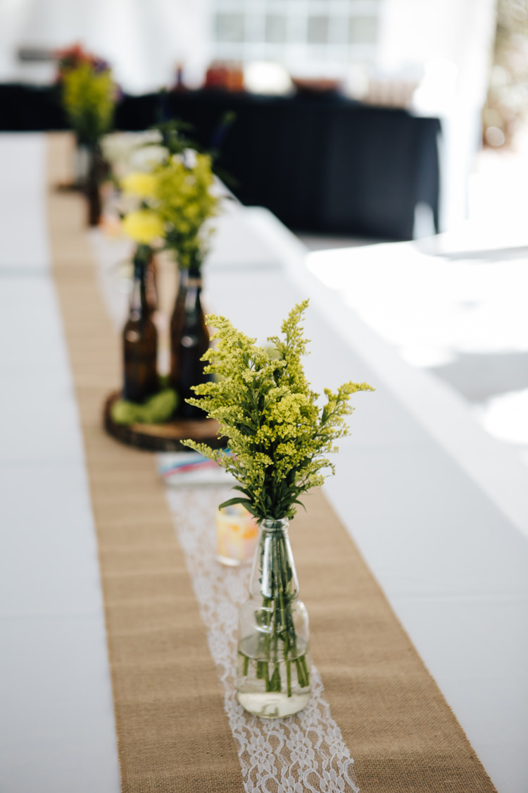 Reception Table Setting Hessian Lace Table Runner Glass Beer Bottle Vases Fresh Florals Wood Slice Adventure Inspired Woodland Wedding North Carolina http://www.amandasuttonphotography.com/