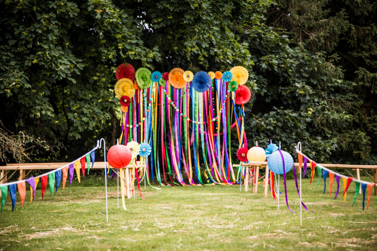 Ribbon Backdrop Pinwheels Lanterns Bunting Outdoor Rainbow Colourful Vintage Comic Book Wedding Ideas http://www.hayleypettitphotography.com/