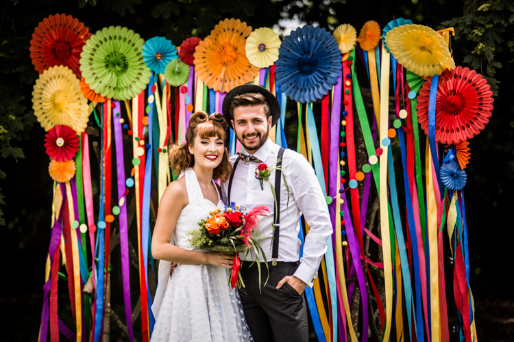 Ribbon Backdrop Pinwheels Lanterns Bunting Outdoor Rainbow Colourful Vintage Comic Book Wedding Ideas http://www.hayleypettitphotography.com/