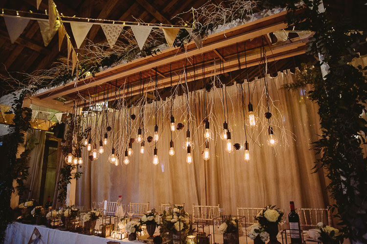 Top Table Festoon Edison Lights Hanging Bunting Flowers Candles Decor Magical Winter Rustic Wonderland Wedding http://hayleybaxterphotography.com/