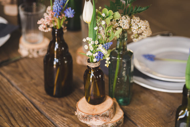 Brown Bottle Flowers Log Decor Magical Spring Bluebell Woodland Wedding Ideas http://helinebekker.co.uk/