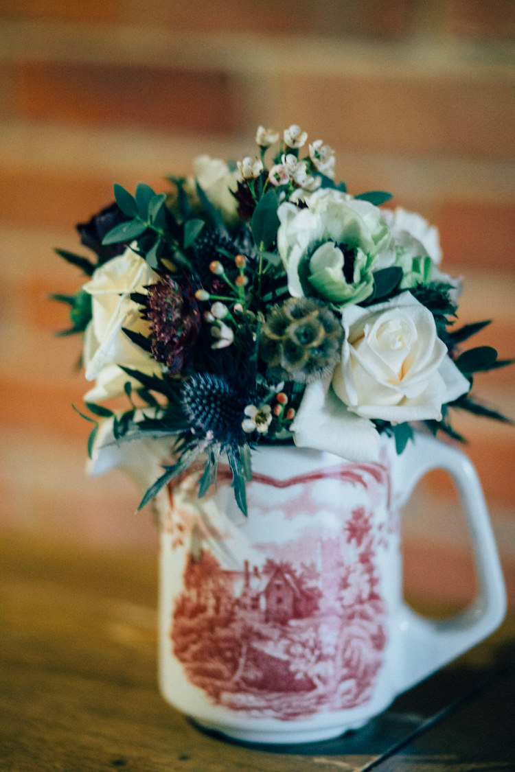 Table Arrangement Jug Thistle Rose Heartwarming Festive Winter Wedding http://www.nikkivandermolen.com/