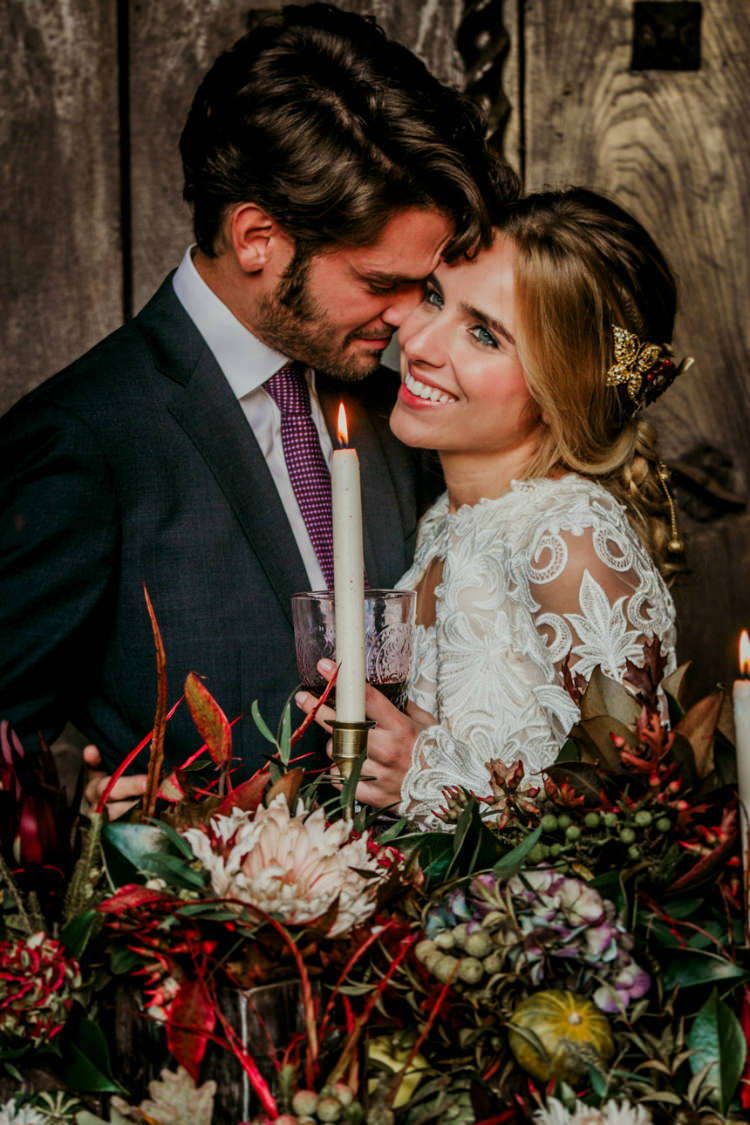 Bride Lace Backless Bridal Gown Intricate Autumn Leaves Headpiece Groom Charcoal Suit Purple Patterned Tie Rustic Reception Table Setting Fresh Flowers Gold Candlesticks From Dawn To Eternity Autumnal Wedding Ideas http://www.nataliaibarra.com