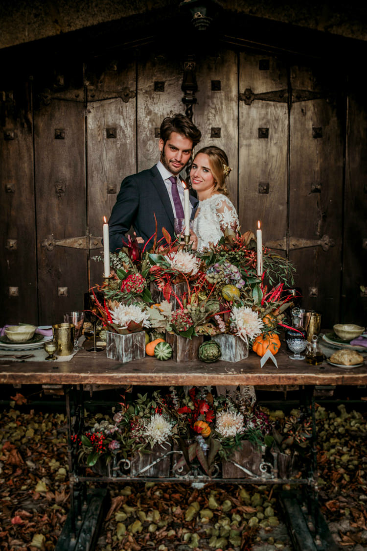 Bride Lace Backless Bridal Gown Intricate Autumn Leaves Headpiece Groom Charcoal Suit Purple Patterned Tie Rustic Reception Table Setting Fresh Flowers Pumpkins Gold Candlesticks From Dawn To Eternity Autumnal Wedding Ideas http://www.nataliaibarra.com
