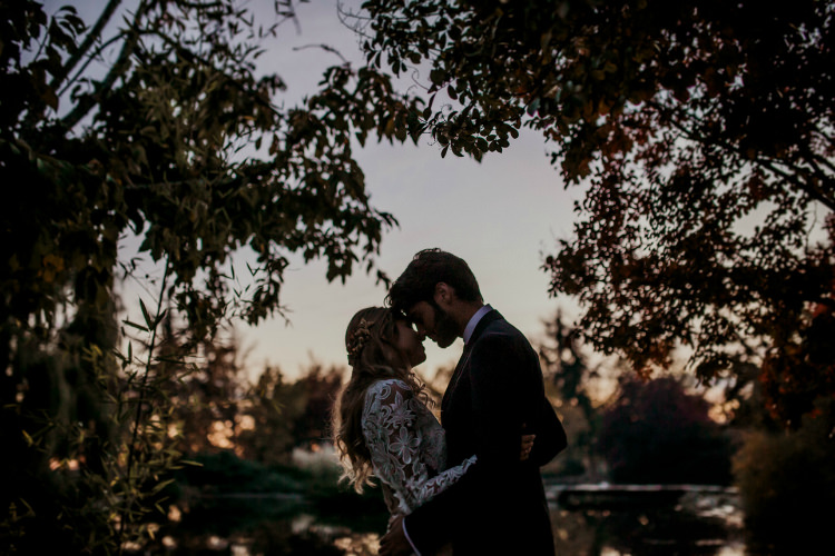 Bride Lace Backless Bridal Gown Intricate Autumn Leaves Headpiece Groom Charcoal Suit Lake Sunset From Dawn To Eternity Autumnal Wedding Ideas http://www.nataliaibarra.com